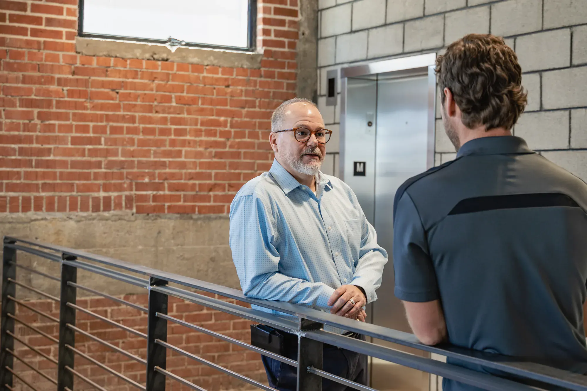 Greg Bennett in conversation with a colleague